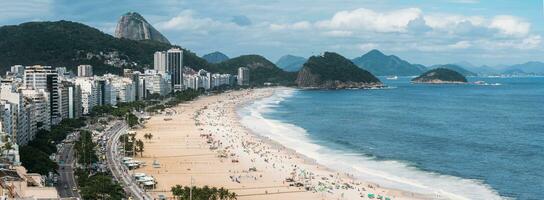 High perspective panoramic view of Copacabana Beach in Rio de Janeiro, Brazil with Sugarloaf mountain visible in the far background photo