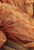 a pile of orange fishing nets photo