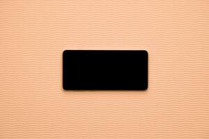 Horizontal blank phone on wave background peach color of the year 2024 photo