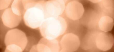 christmas beautifull shiny Peach Fuzz background. sparkle festive blurred bokeh photo