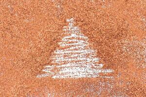 finger drawn christmas tree on shiny Peach Fuzz confetti background photo