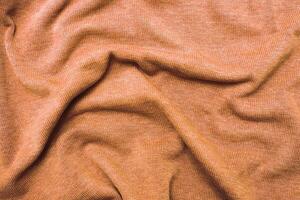 burgundy Peach Fuzz wrinkled plush fabric background texture, soft material pattern photo