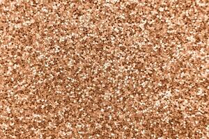 glittering background of Peach Fuzz sequins closeup. Sparkle festive texture photo