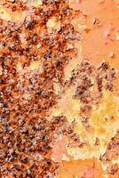 rusty orange paint on a metal surface photo