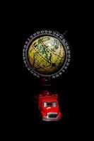 a red truck and a globe on a black background photo