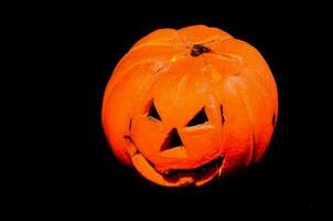 a halloween pumpkin is shown in the dark photo