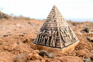 a pyramid shaped object with egyptian symbols on it photo