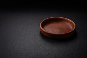 Bumpy empty ceramic plate on a textured concrete background photo