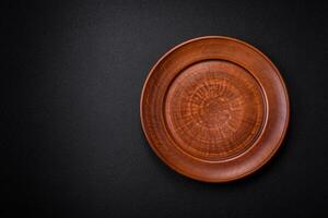 Bumpy empty ceramic plate on a textured concrete background photo