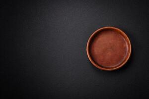 Bumpy empty ceramic plate on a textured concrete background photo