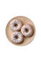 Delicious fresh donut of white or beige color with silver beads and cream photo