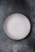 Empty round ceramic plate as an item of kitchen utensils photo