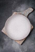 Empty round ceramic plate as an item of kitchen utensils photo