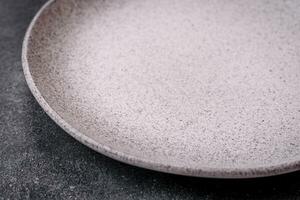 Empty round ceramic plate as an item of kitchen utensils photo