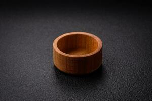 A cylindrical empty container made of wood for spices or salt photo