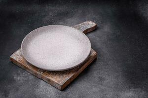 Empty round ceramic plate as an item of kitchen utensils photo