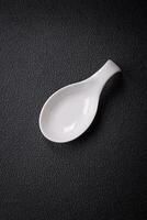 Beautiful empty white ceramic gravy boat on a textured concrete background photo