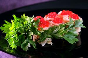 Sandwiches with red caviar, decorated with herbs on a dark background. Delicious Healthy food Breakfast lunch dinner photo