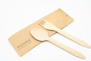 Wooden Cutlery with Paper Packaging, Eco Tableware, Disposable Cutlery, Recycle. Eco food packaging concept, zero waste paper, sustainability. photo