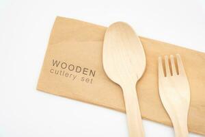 Wooden Cutlery with Paper Packaging, Eco Tableware, Disposable Cutlery, Recycle. Eco food packaging concept, zero waste paper, sustainability. photo