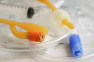 Foley catheter and urine drainage bag collect urine for disability or patient in hospital. photo