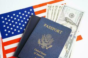 US passport with dollar money on USA flag, American citizen in United States of America. photo