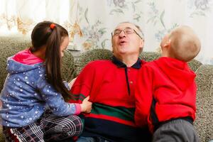 Grandparents spending time with grandchildren on couch photo