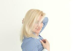 Portrait of emotive good-looking caucasian woman laughing while looking aside and standing against white background. photo