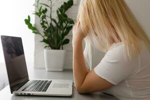 Business woman in bad mood failed and has problem while working with the laptop at cafe. Having headaches. photo