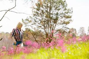 Lifestyle summer image of pretty blonde hipster woman with bag pack traveling and enjoying, stylish fresh look, happy mood, sunny colors, travel concept, emotions. photo