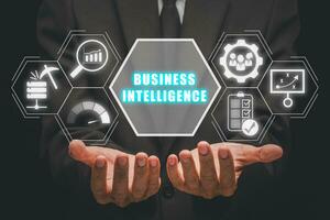 Business intelligence concept, Businessman hand holding business intelligence icon on virtual screen, data mining, analysis, Strategy, measurement, benchmarking, report and management. photo