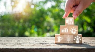 Knowledge concept, Man hand holding wooden block on desk with knowledge icon on virtual screen. photo