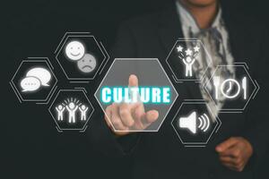 Culture concept, Business woman hand holding culture icon on virtual screen. photo