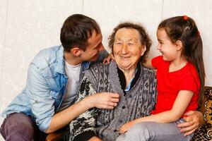 grandma hug grand children they grimacing close up photo