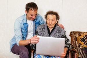 Closeup of elderly woman with young man photo