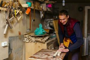 handsome joiner work in carpentry. He is successful entrepreneur at his workplace. photo