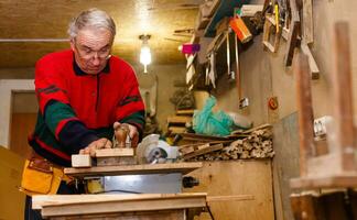 Carpenter works in a workshop for the production of vintage furniture photo