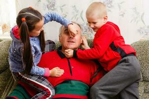 Grandparents spending time with grandchildren on couch photo