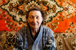 Senior Woman Relaxing In Chair At Home photo