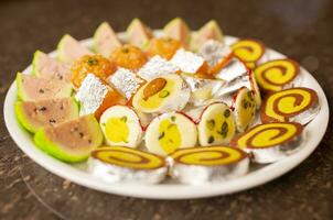 Indian Traditional Mix Sweets Food Served in Special Decorative Plate on Vintage Background photo