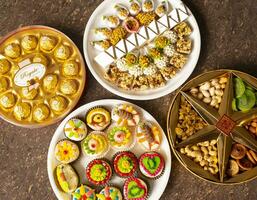 Indian Traditional Mix Sweets Food Served in Special Decorative Plate on Vintage Background photo