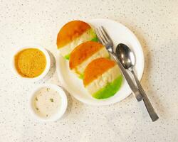 South Indian Popular Breakfast Idli Served With Sambar And Coconut Chutney Also Know as Idly photo