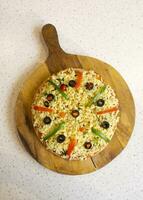 Vegetarian Delicious Capsicum Pizza Made From Capsicum, Cheese, Tomatoes, Peppers, Onions And Olives photo