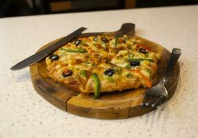 Vegetarian Delicious Capsicum Pizza Made From Capsicum, Cheese, Tomatoes, Peppers, Onions And Olives photo