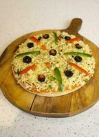 Vegetarian Delicious Capsicum Pizza Made From Capsicum, Cheese, Tomatoes, Peppers, Onions And Olives photo