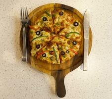 Vegetarian Delicious Capsicum Pizza Made From Capsicum, Cheese, Tomatoes, Peppers, Onions And Olives photo