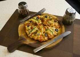 Vegetarian Delicious Capsicum Pizza Made From Capsicum, Cheese, Tomatoes, Peppers, Onions And Olives photo