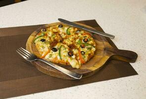 Vegetarian Delicious Capsicum Pizza Made From Capsicum, Cheese, Tomatoes, Peppers, Onions And Olives photo