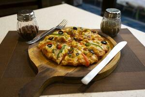 Vegetarian Delicious Capsicum Pizza Made From Capsicum, Cheese, Tomatoes, Peppers, Onions And Olives photo