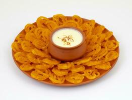 Jalebi, also Know as imarti, imarati, paneer jalebi or zulbia is a Indian sweet food, It is made by deep-frying a wheat flour batter in pretzel or circular shapes photo